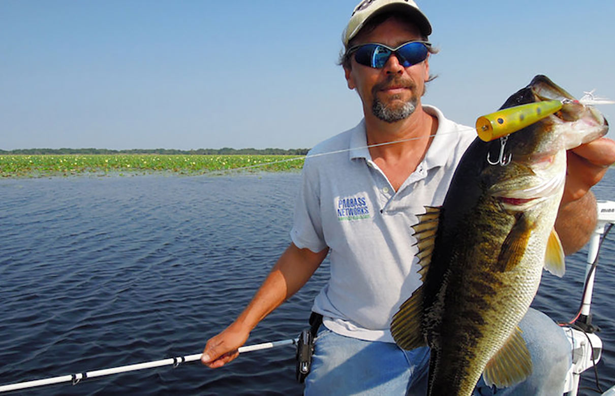 Tim Fey shows off a bass he caught on a high roller topwater bait while fishing on Lake Jackson south of St. Cloud, Florida. (John N. Felsher photo)