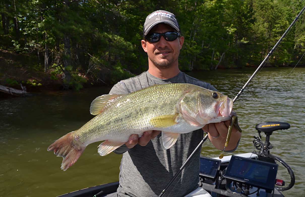 Keith Poche, a professional bass angler from Pike Road, Ala., shows off a bass he caught on a tail-spinner worm while fishing West Point Lake. (John N. Felsher photo)