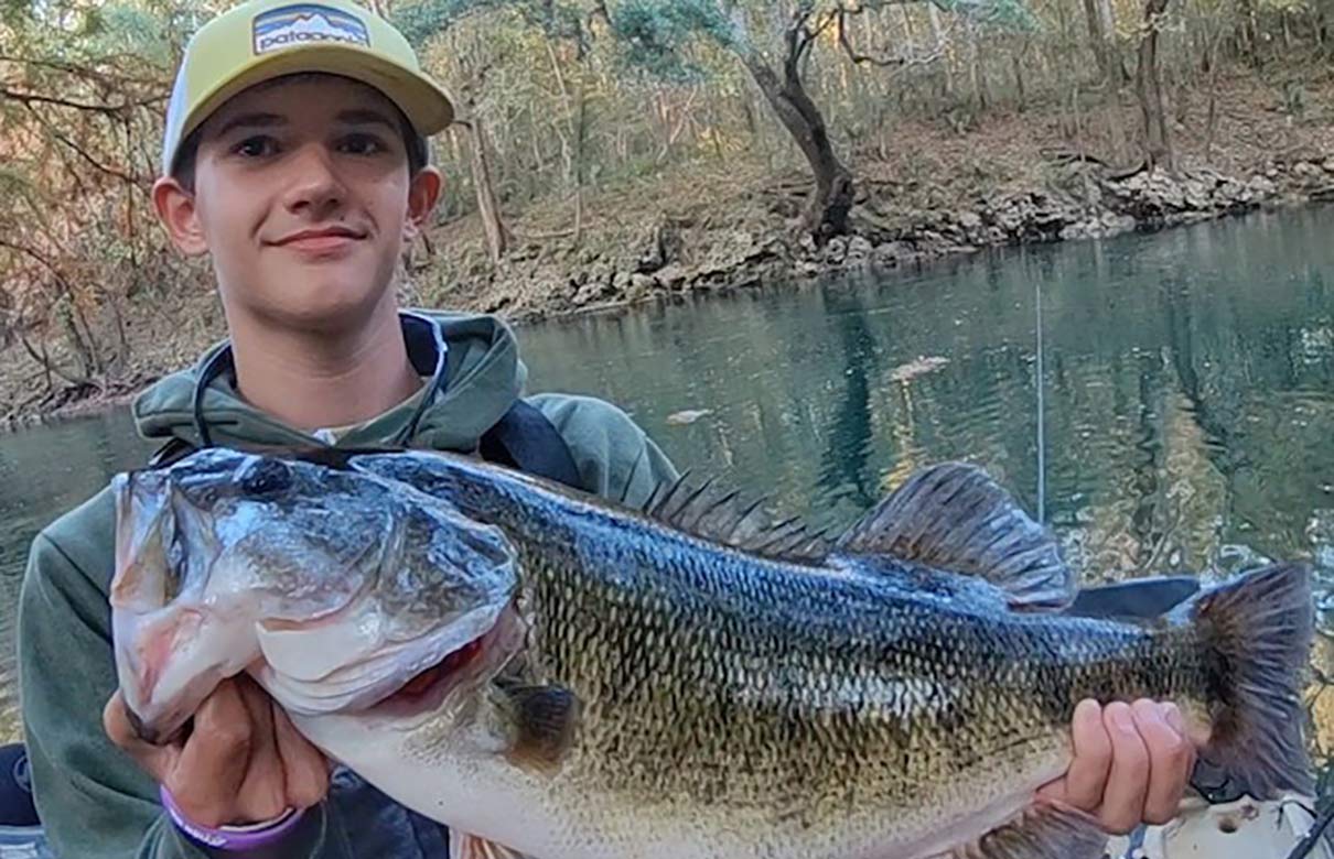 Sheldon Grace with his Florida state record shoal bass. (Photo courtesy of Clay Grace/FWC)